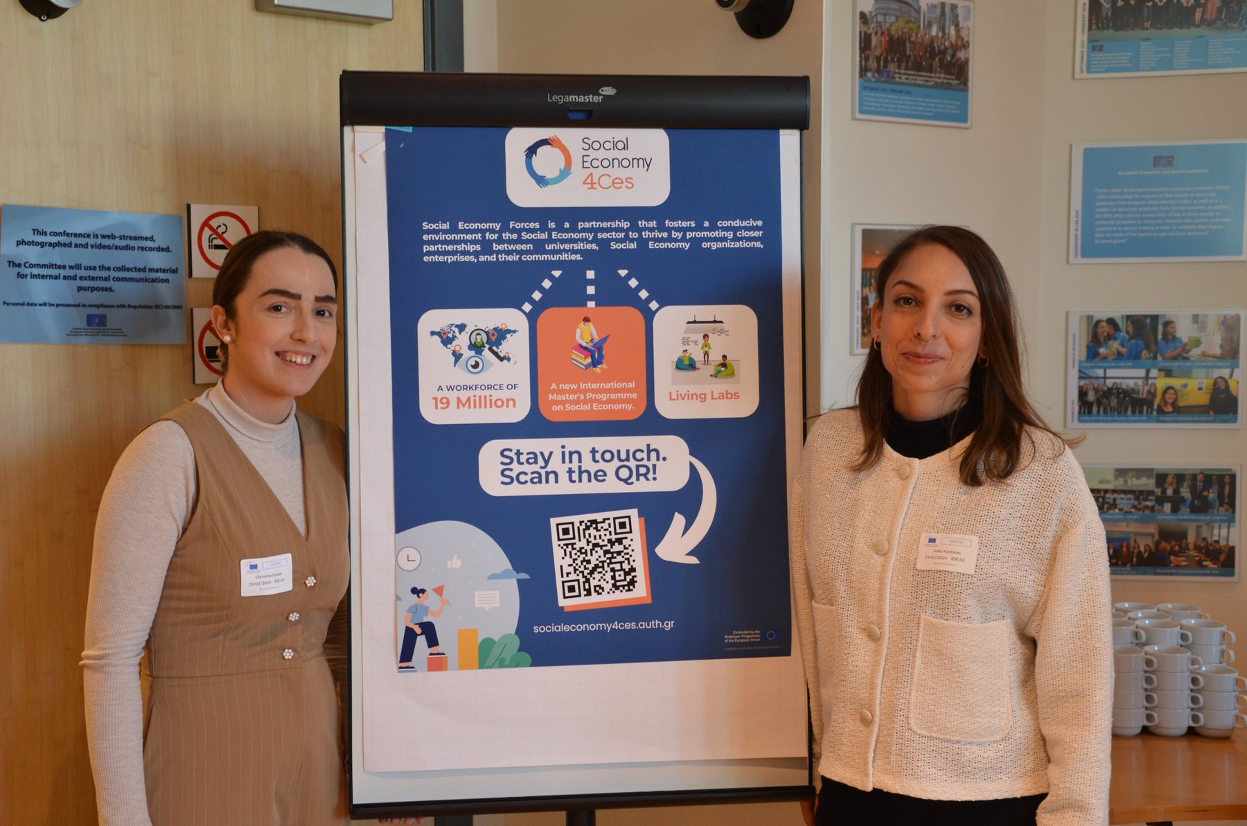 Our partners from Stimmuli for Social Change next to the project poster I designed